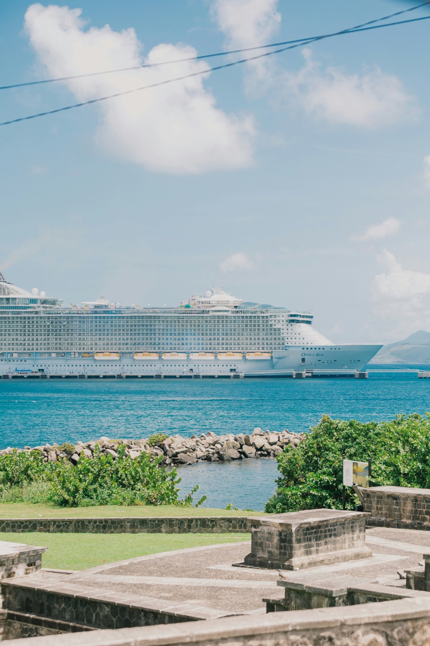 Sunny harbour with a cruise ship in bright blue water